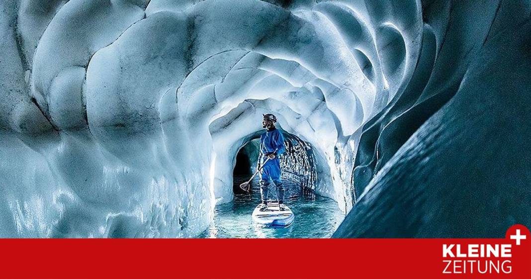 wo-man-auf-einem-surfbrett-durch-den-gletscher-faehrt